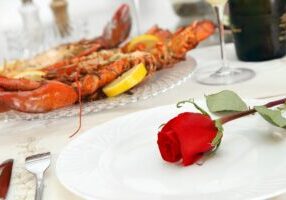 Fine Dining with Grilled Lobster and Red Rose on the Plate
